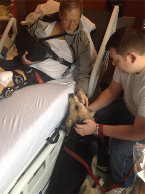 Lucy visit her injured owner, John Miles, at the hospital just days after the accident. (MSPCA-Angell)