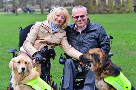 Sue and Byron Harvey with their service dogs Max (r) and Ziggy.