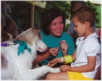 Melannie Layne and Mike visit with a child at a local hospital.