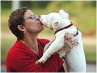 Cathy Miller Saye plays with one of her deaf dogs at a Marietta, GA park.